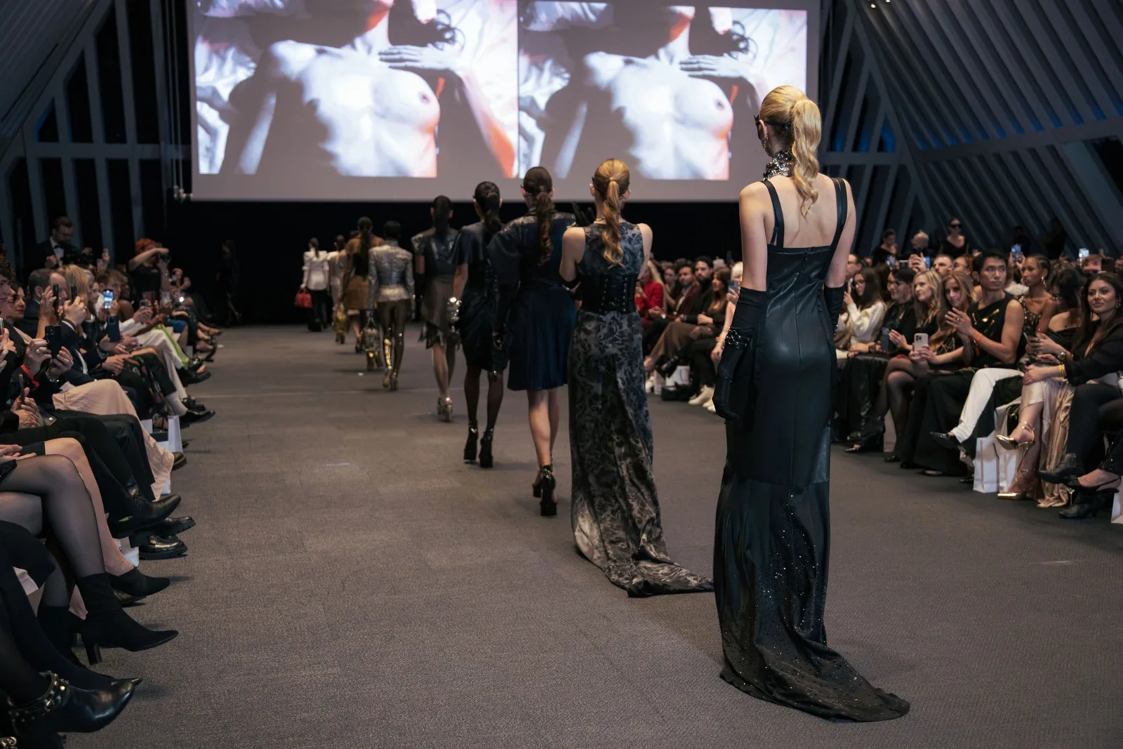 Model in a gold sequinned gown walking the Couture Fashion Night runway