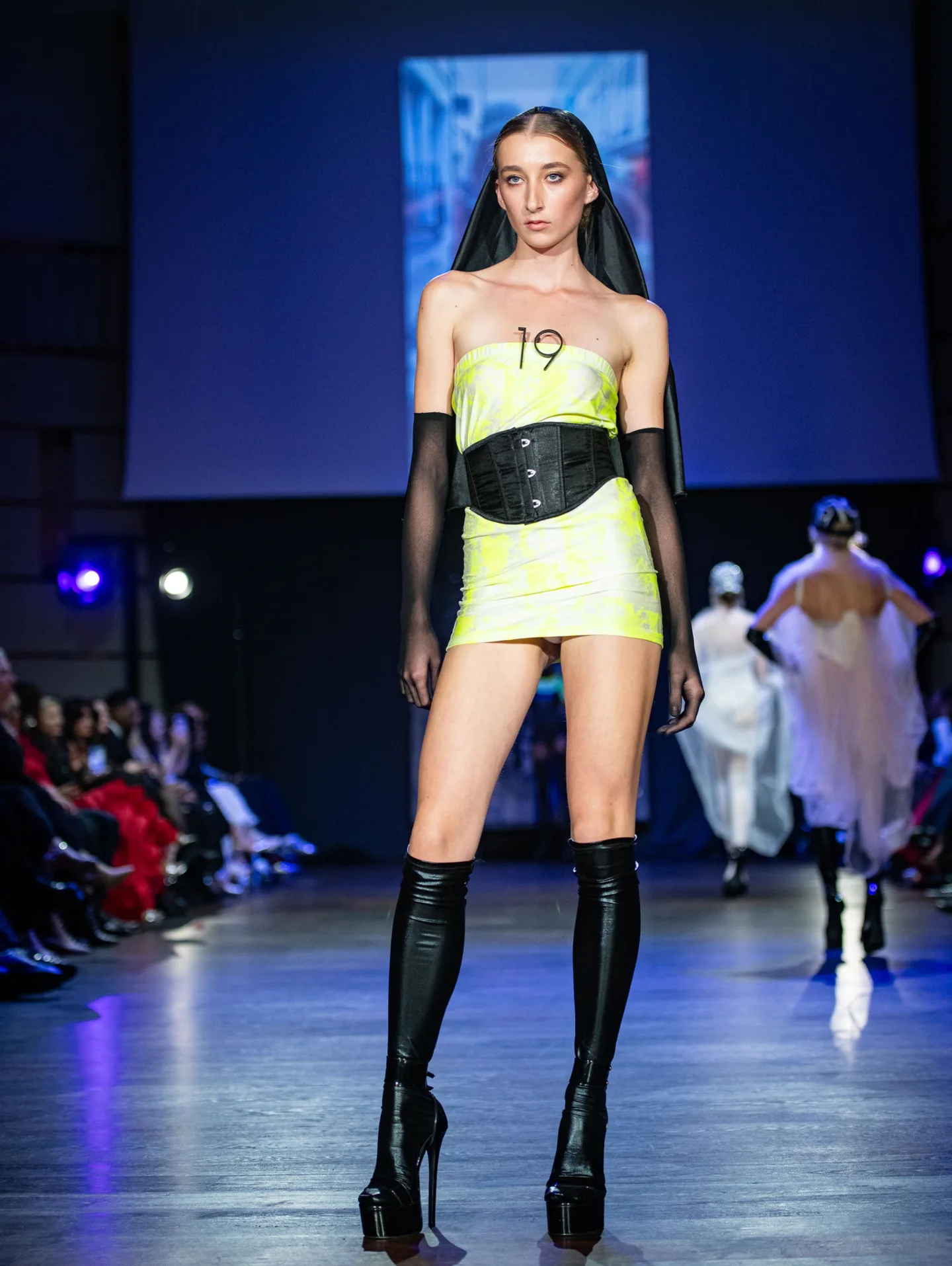 Model wearing neon yellow and black outfit by Pardessus19 on the CFN 4.0 runway